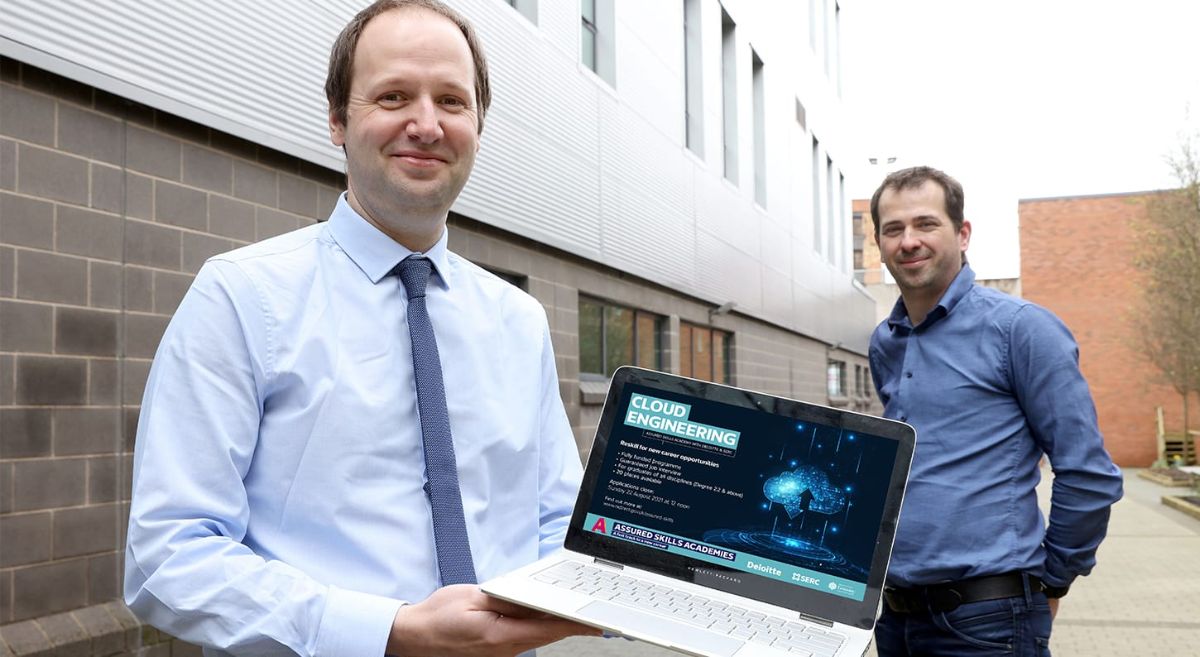 Photo of Lecturing staff holing lap top promoting Cloud Engineering